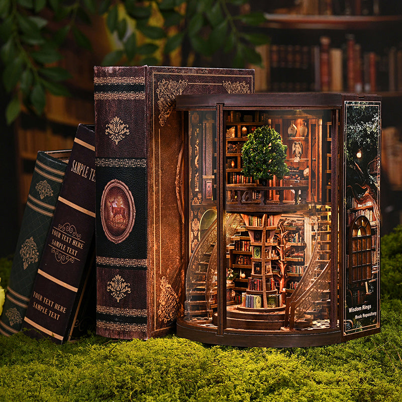 Enchanted Library book nook placed between vintage books on a mossy surface, showing warm amber LED glow and two-story interior