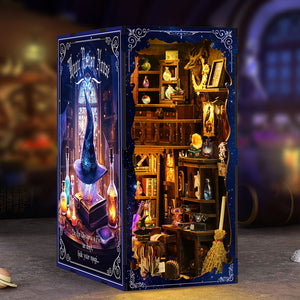 Magic Potion House book nook displayed between real books showing full starry blue side panel and warm LED interior glow