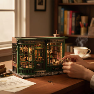 A hand adjusts the illuminated Chronos Arcanum Magic Wand book nook on a stone table in a beautiful, warm, enchanted forest setting.