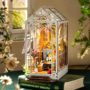 The Garden House miniature kit displayed on top of large books, highlighting its use as desktop or shelf decor.