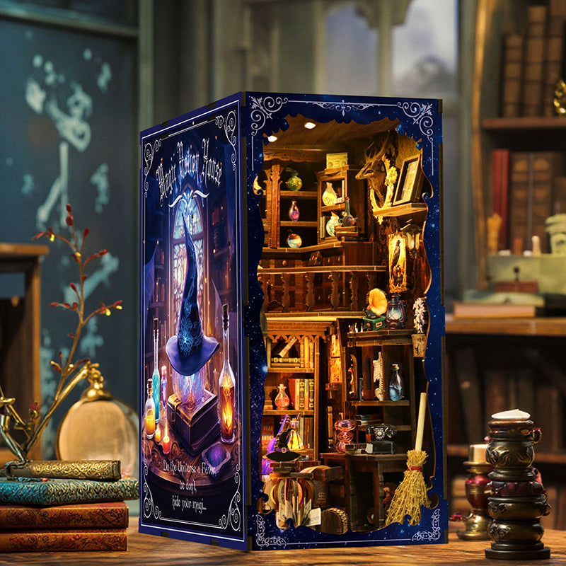 Magic Potion House book nook side angle view showing starry night blue panel and warm LED glow on a wooden desk