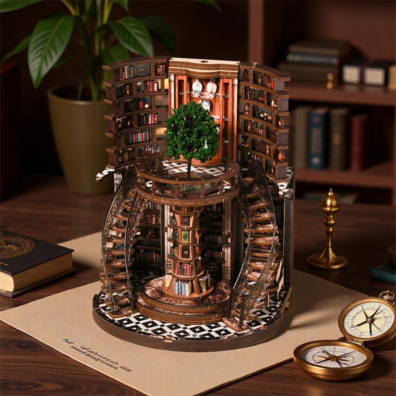 Assembled Enchanted Library circular book nook on wooden desk next to antique compass and books, showing full open 360-degree rotunda design