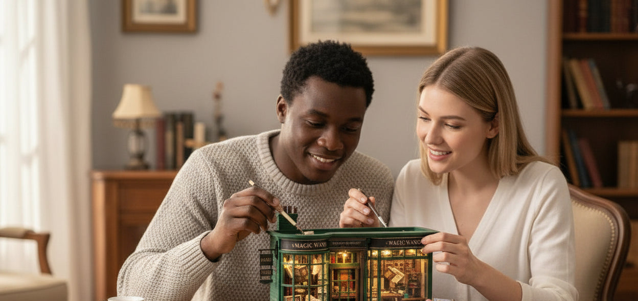Happy couple working together to assemble the illuminated green Magic Wand Shop book nook miniature kit on a wooden table, emphasizing the crafting and bonding experience.